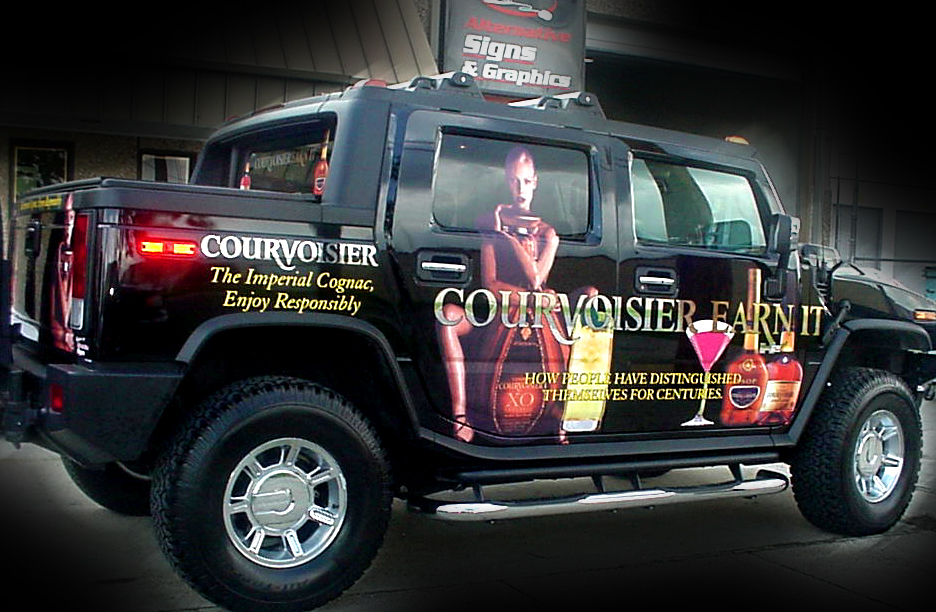 Installation of vehicle wrap in Metairie Louisiana for Courvoisier vehicle